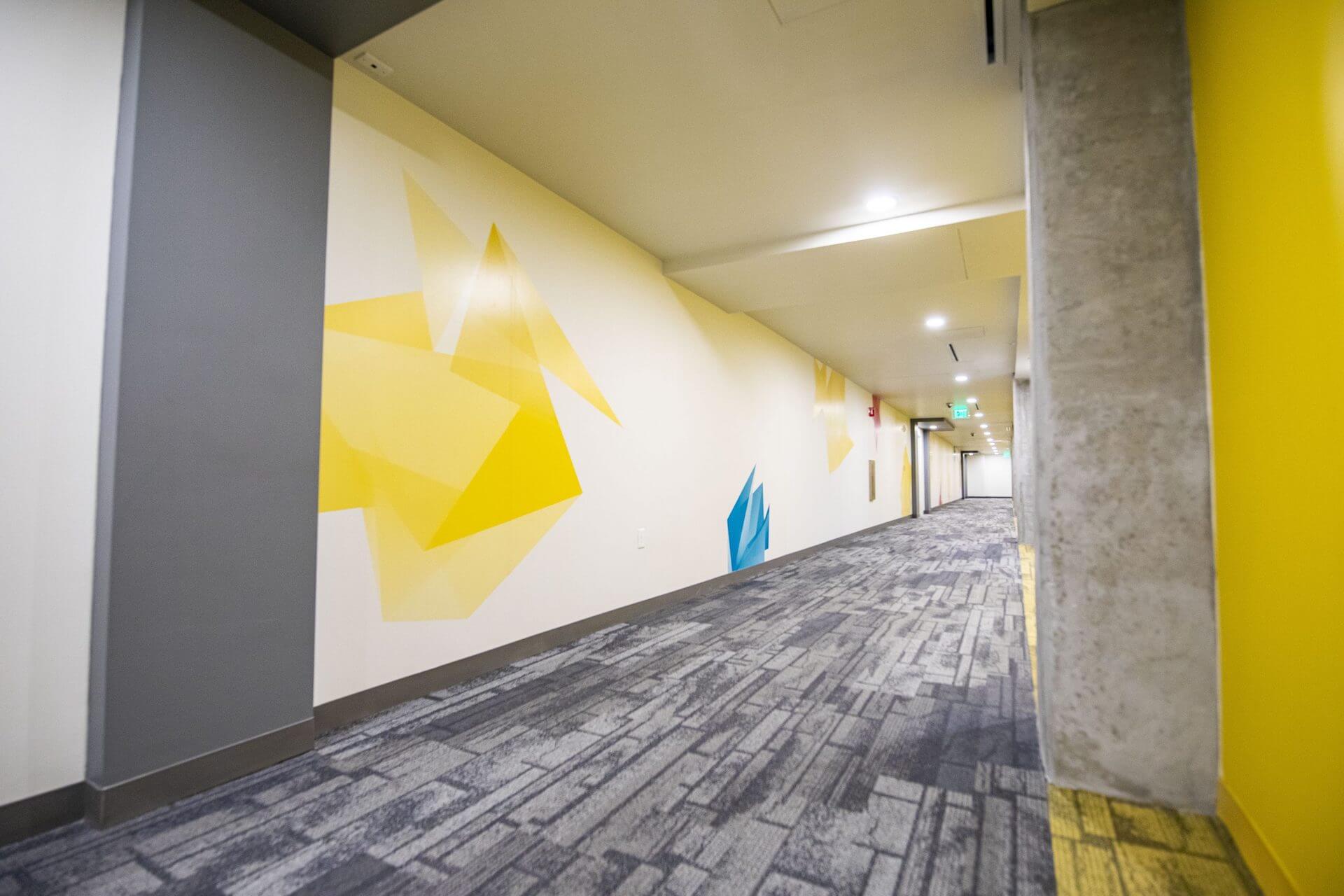 A large hallway with yellow and blue pattern on walls